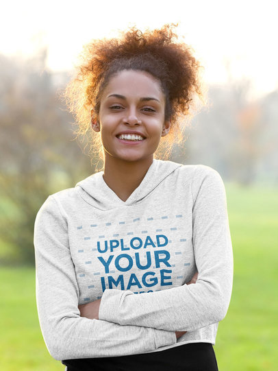 Crop Top Hoodie Mockup of a Happy Woman Posing With Her Arms Crossed