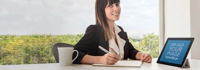 Product Mockup Featuring a Business Woman Using an iPad at an Office