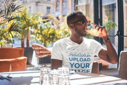 Mockup of a Man with a V-Neck Tee Drinking a Beer at a Bar