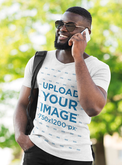 Mockup of a Stylish Bearded Man Wearing a Heather V-Neck Tee on the Street
