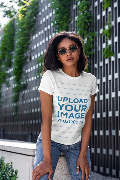 T-Shirt Mockup Featuring a Woman and Plants in the Background