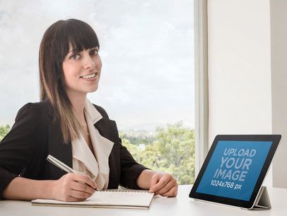 iPad Mockup Featuring a Business Woman Using an iPad at an Office