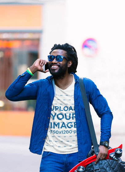 T-Shirt Mockup of a Bearded Man with a Skateboard Talking on the Phone 