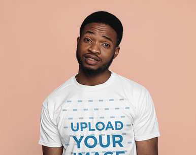 T-Shirt Mockup Featuring a Young Bearded Man in a Studio