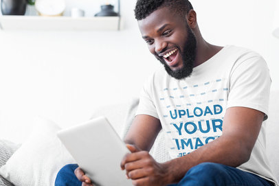 T-Shirt Mockup Featuring an Excited Man at Home