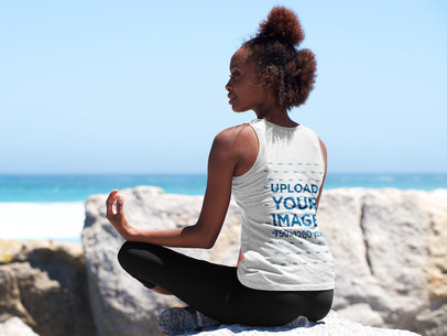 Back-View Tank Top Mockup of a Woman Meditating at the Beach
