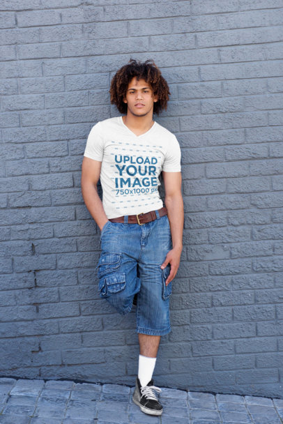 V-Neck Tee Mockup of a Man Leaning Against a Gray Concrete Wall 37818-r-el2
