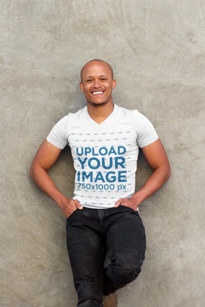 Mockup of a Happy Man with a V-Neck T-Shirt Leaning on a Wall