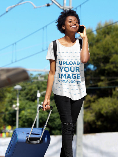 Mockup of a Woman with a Loose T-Shirt Carrying a Suitcase