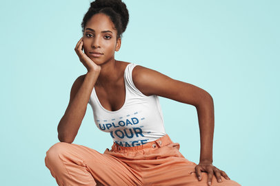 Mockup of a Woman Wearing a Tank Top Posing in a Studio