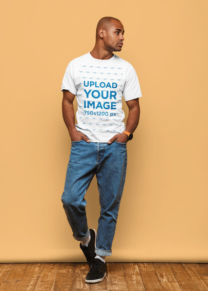 T-Shirt Mockup of a Man Casually Posing in a Studio