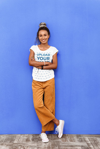 T-Shirt Mockup Featuring a Happy Woman Posing Against a Colored Wall 38806-r-el2
