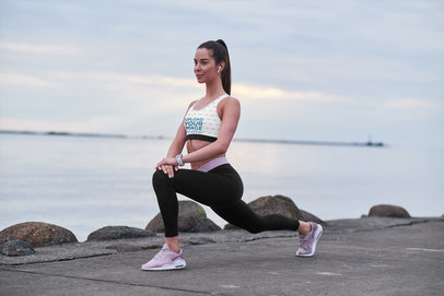 Sublimated Sports Bra Mockup Featuring a Woman Warming Up