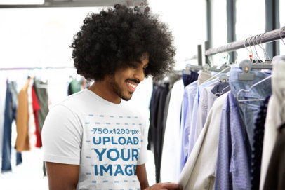 T-Shirt Mockup of a Man at a Clothing Store