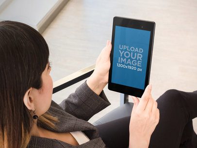 Over Shoulder Mockup Featuring a Woman Using a Nexus 7 