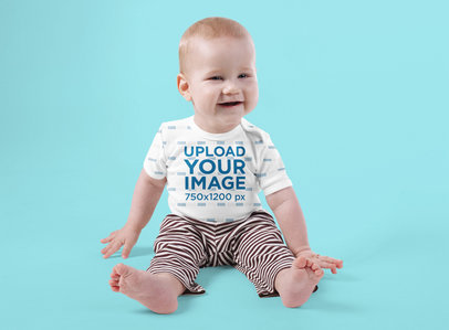 Onesie Mockup Featuring a Joyful Baby Sitting Against a Colored Backdrop 35683-r-el2