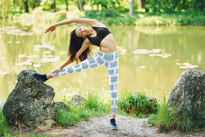 Leggings Mockup of an Athletic Woman Stretching by a Pond