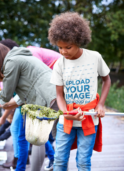 T-Shirt Mockup Featuring a Boy Holding a Fishing Net 