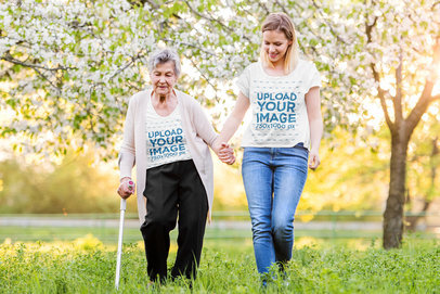 T-Shirt Mockup Featuring a Woman and Her Grandma Walking at a Park 39026-r-el2