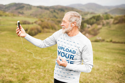 Long-Sleeve Tee Mockup of a Senior Man Taking a Selfie at the Mountains 