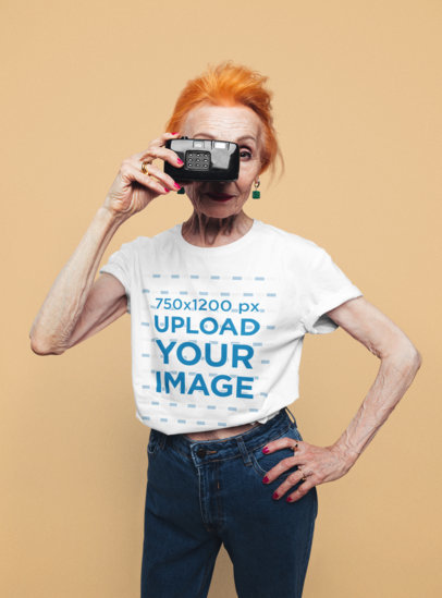 T-Shirt Mockup of a Senior Woman Holding a Camera 
