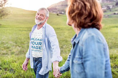 V-Neck T-Shirt Mockup of a Happy Senior Man Holding Hands with His Wife