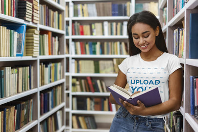 Crewneck Tee Mockup of a Young Student Reading in the Library