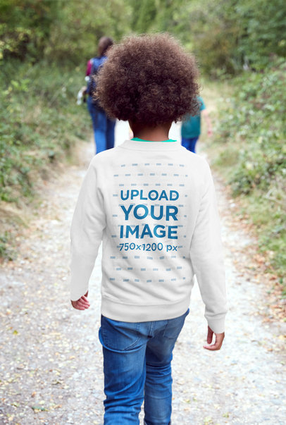 Back-View Sweatshirt Mockup of a Boy With Curly Hair Walking on a Trail 