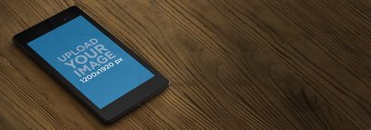 Mockup of a Nexus 7 Black on a Wooden Desktop 