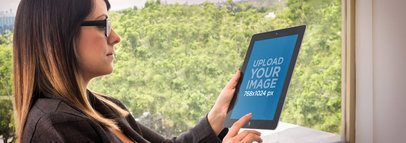 Product Mockup of a Woman using an iPad at the Office 