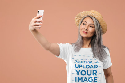 Selfie Mockup of a Middle-Aged Woman with a T-Shirt at a Studio