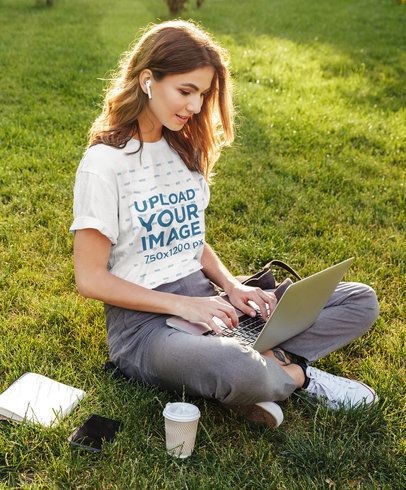 T-Shirt Mockup of a Young Woman Working at a Park 
