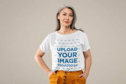 Mockup of a Senior Woman Wearing a T-Shirt and Posing at a Studio 