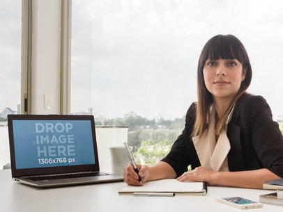 Mockup of a Business Woman Using a Laptop at the Office