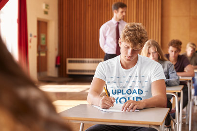 T-Shirt Mockup of a College Student Taking an Exam in a Classroom