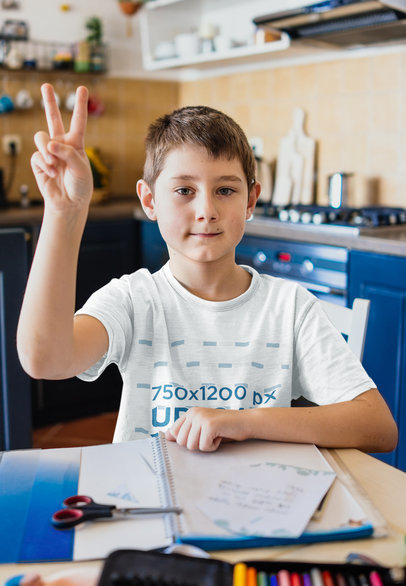 T-Shirt Mockup of a Boy Studying in the Kitchen