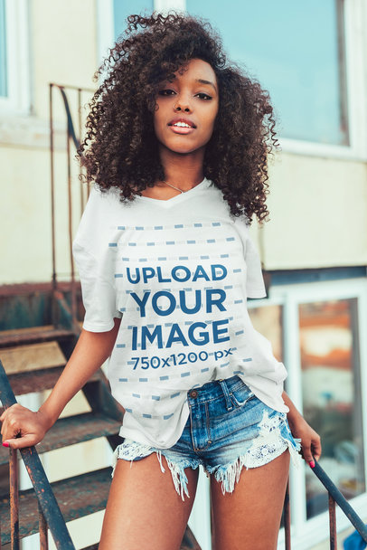 Mockup of a Young Woman Wearing an Oversized V-Neck T-Shirt 