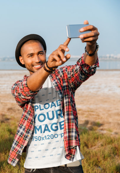 T-Shirt Mockup of a Man Wearing a Flannel Shirt and Taking a Selfie