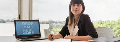Product Mockup of a Business Woman Using an Laptop At the Office 