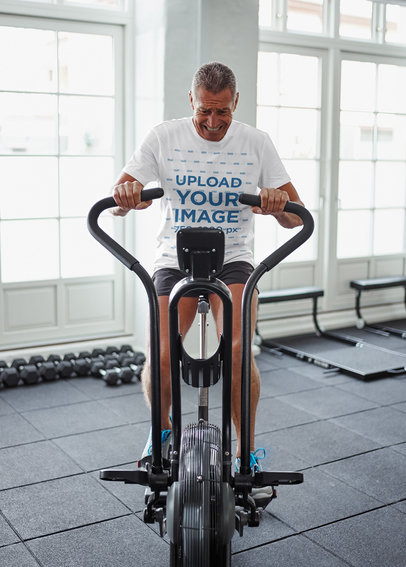 T-Shirt Mockup of a Senior Man Doing Cardio at the Gym