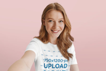 T-Shirt Mockup of a Smiling Woman Taking a Selfie