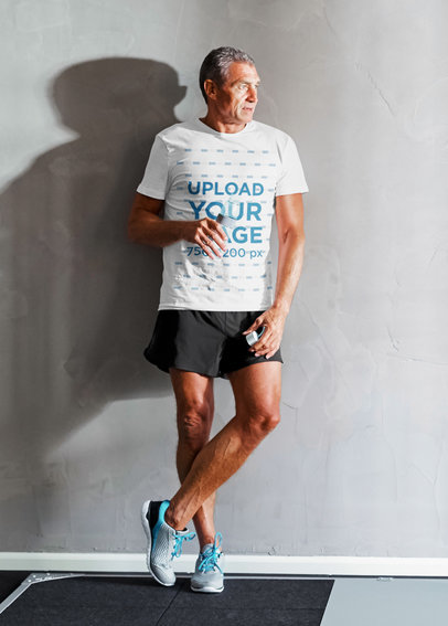 T-Shirt Mockup of a Senior Man Resting During His Workout