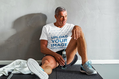 T-Shirt Mockup Featuring a Senior Man Resting After a Workout 