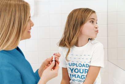 Mockup of a Girl with a T-Shirt Putting on Makeup with Her Mom 