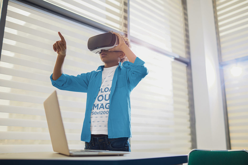 T-Shirt Mockup of a Young Boy Using a VR Headset in a Classroom