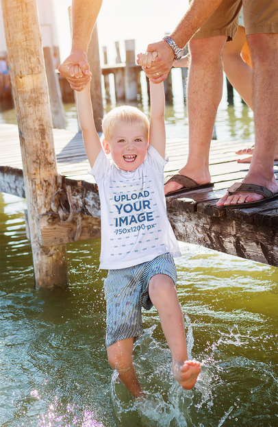 T-Shirt Mockup Featuring a Happy Kid Playing With His Father at a Lake 