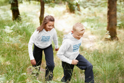 Hoodie Mockup Featuring a Boy and a Girl at the Mountains
