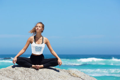 Tank Top Mockup of a Woman Enjoying the Sea Breeze While Meditating
