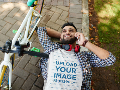 Heather T-Shirt Mockup of a Man Lying on the Floor Next to a Bike 39512-r-el2