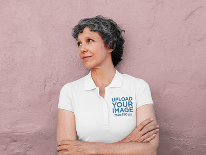 Polo Shirt Mockup of a Senior Woman Posing in Front of a Wall